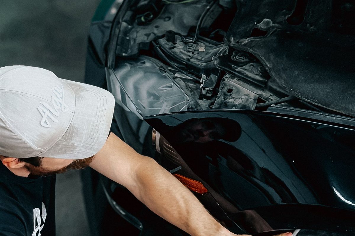 Technician repairing a car bumper